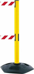 Tensator - 38" High, 2-1/2" Pole Diam, 4 Way Stanchion - 19" Base Diam, Octagon Recycled Rubber Base, Yellow Plastic Post, 7-1/2' x 2" Tape, Dual Line Tape, For Outdoor Use - Top Tool & Supply