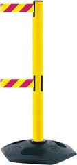 Tensator - 38" High, 2-1/2" Pole Diam, 4 Way Stanchion - 19" Base Diam, Octagon Recycled Rubber Base, Yellow Plastic Post, 13' x 2" Tape, Dual Line Tape, For Outdoor Use - Top Tool & Supply